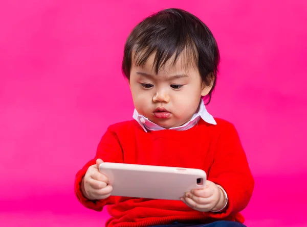 Asian baby boy looking at cellphone — Stock Photo, Image