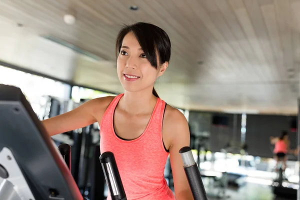 Sport Woman running on Elliptical machine — Stock Photo, Image