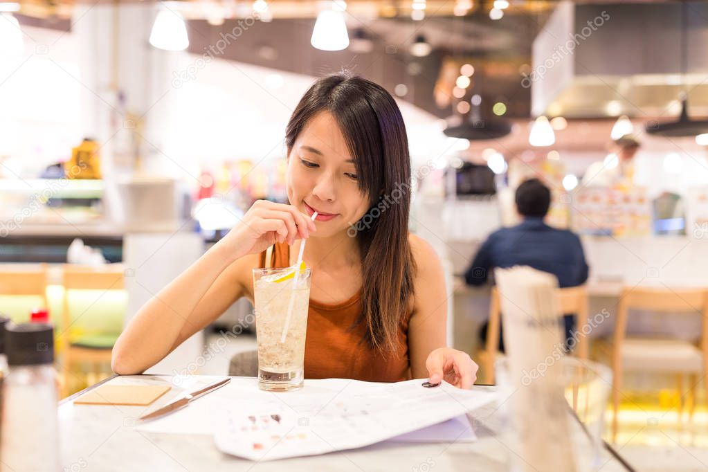Woman enjoy her drink in restaurant