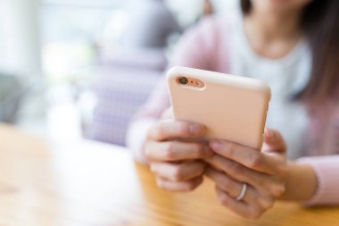 Restoranda cep telefonu kullanan kadın