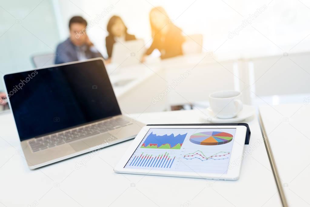 Digital tablet showing graph in meeting room