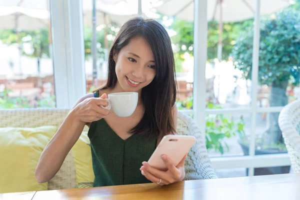 Femme profiter de son café et en regardant le téléphone portable — Photo