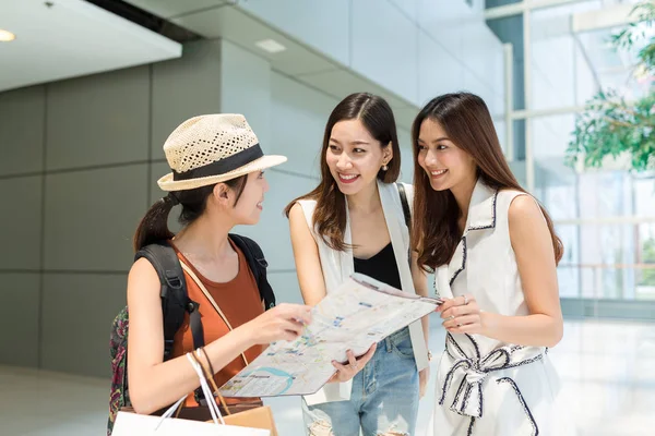 Woman asking the direction on city map from local people