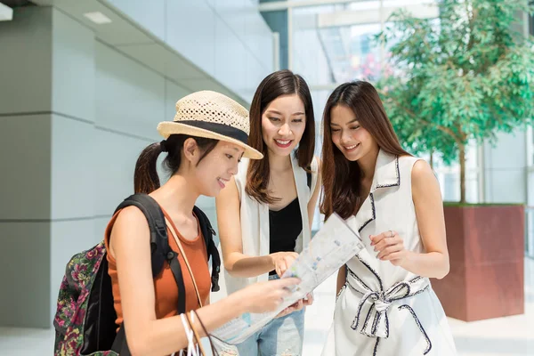 Woman asking the direction on city map