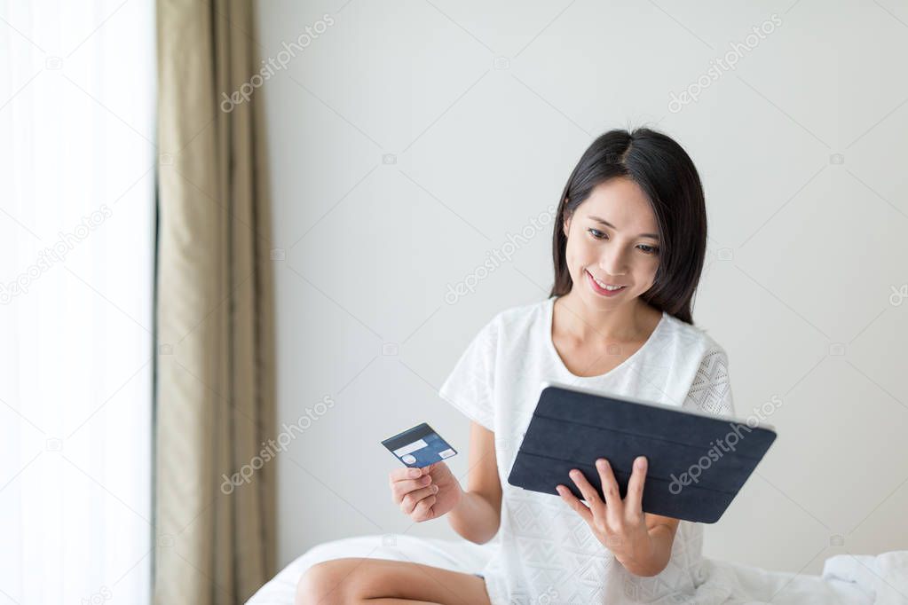 Woman using tablet and credit card