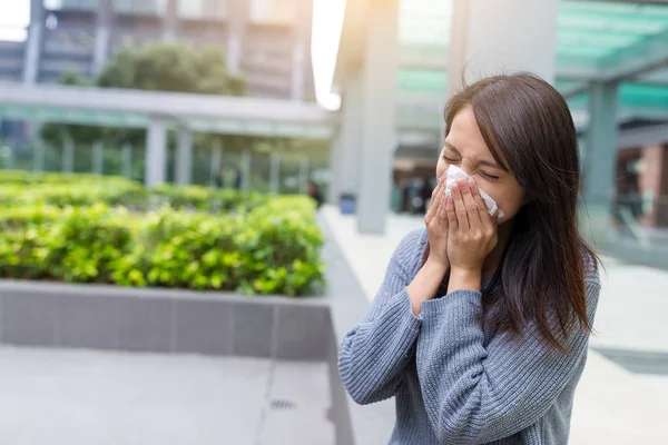 Woman sneezing at outdoor — Stock Photo, Image