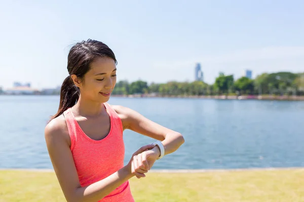 Sport woman using smart watch to search for GPS