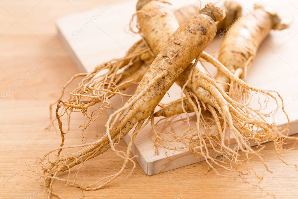 Korean ginseng on wooden background 