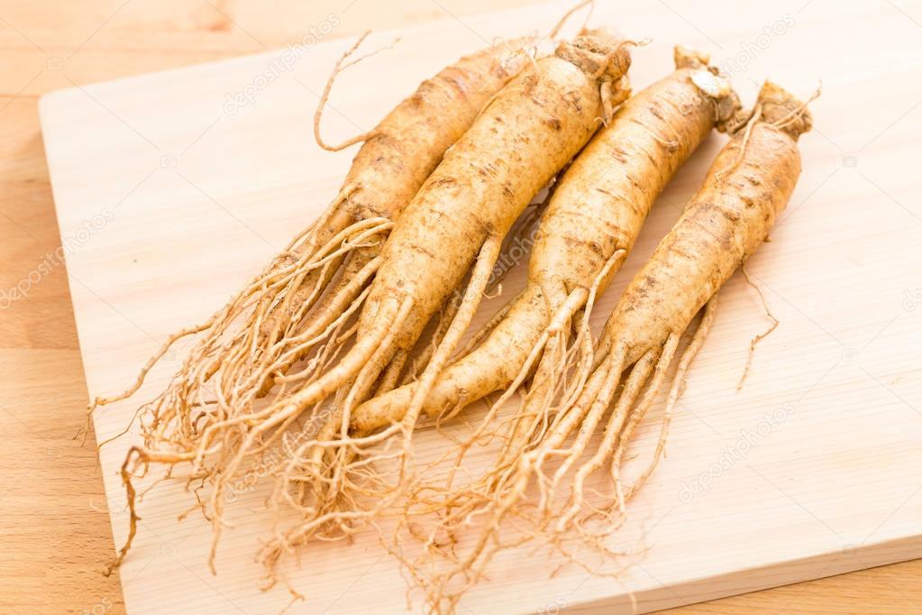 Ginseng over wooden background