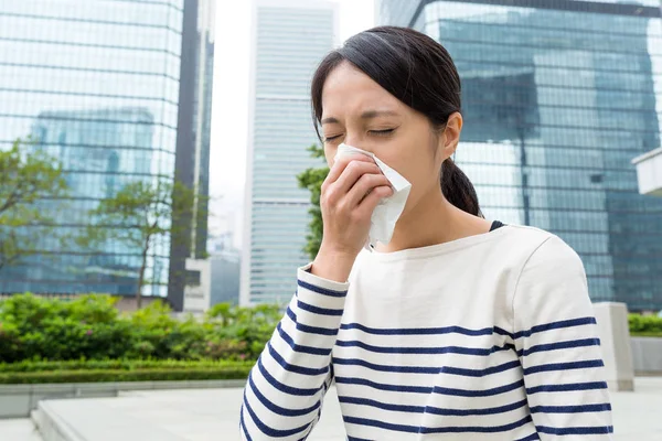 Woman sneezing at outdoor — Stock Photo, Image