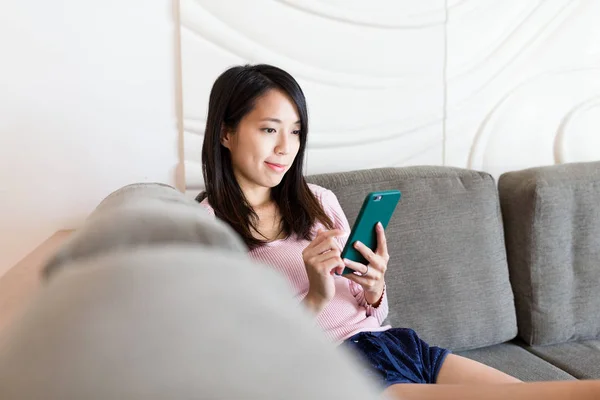 Vrouw met behulp van mobiele telefoon thuis — Stockfoto