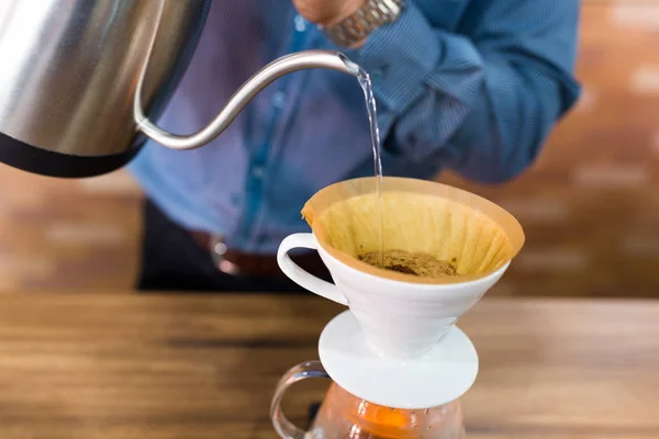 Barista pouring water on coffee filter — Stock Photo, Image