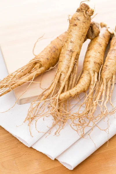 Ginseng over wooden background — Stock Photo, Image