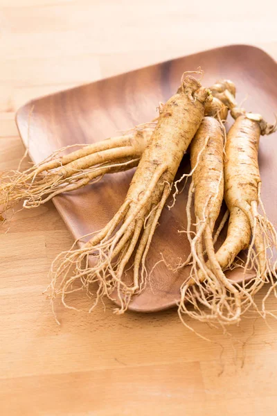 Ginseng over wooden background — Stock Photo, Image