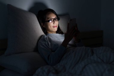 Cep telefonu gece izlerken kadın