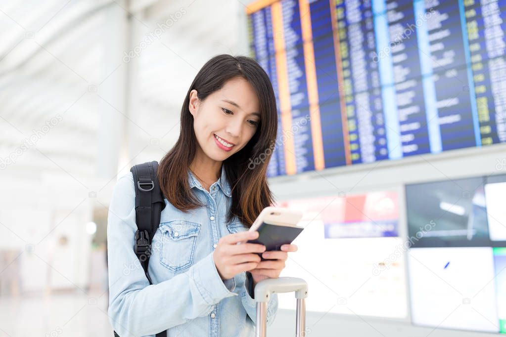 Woman checking the fight number on cellphone 