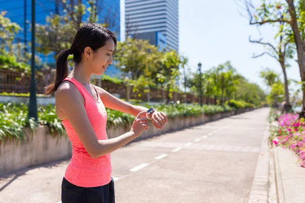 Woman running with smart watch