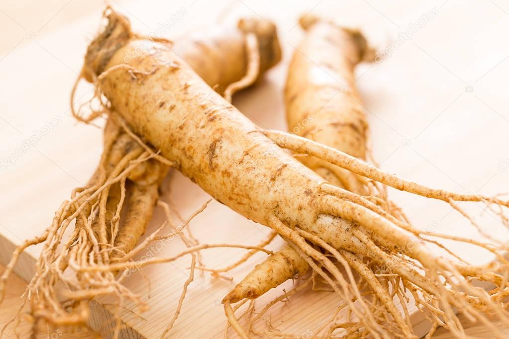 Fresh Ginseng on wooden plate 