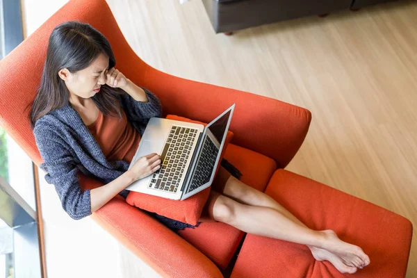 woman feeling eye pain of working on laptop computer