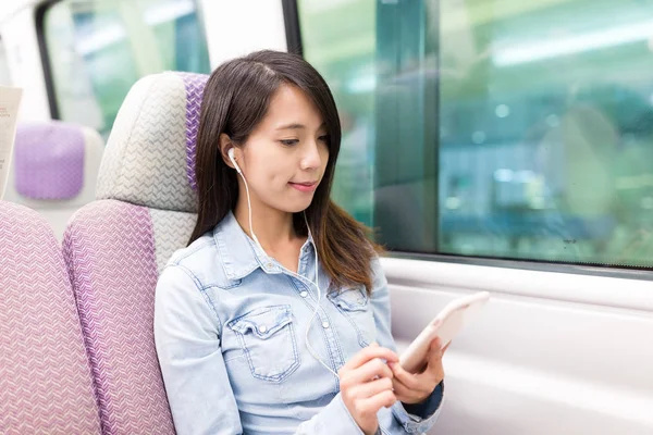 Woman listen to song inside train compartment — Stock Photo, Image