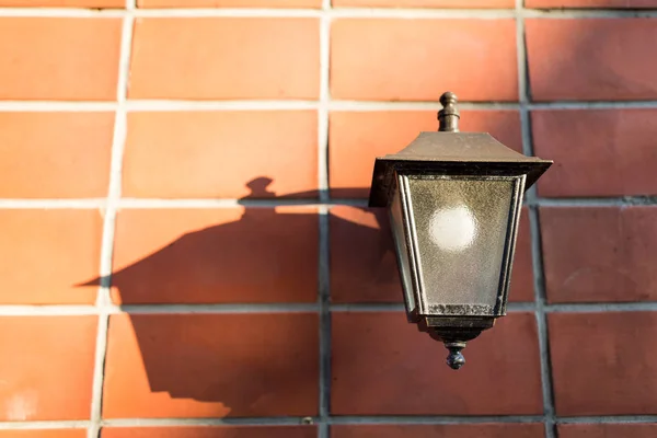 Street lamp over red brick wall — Stock Photo, Image