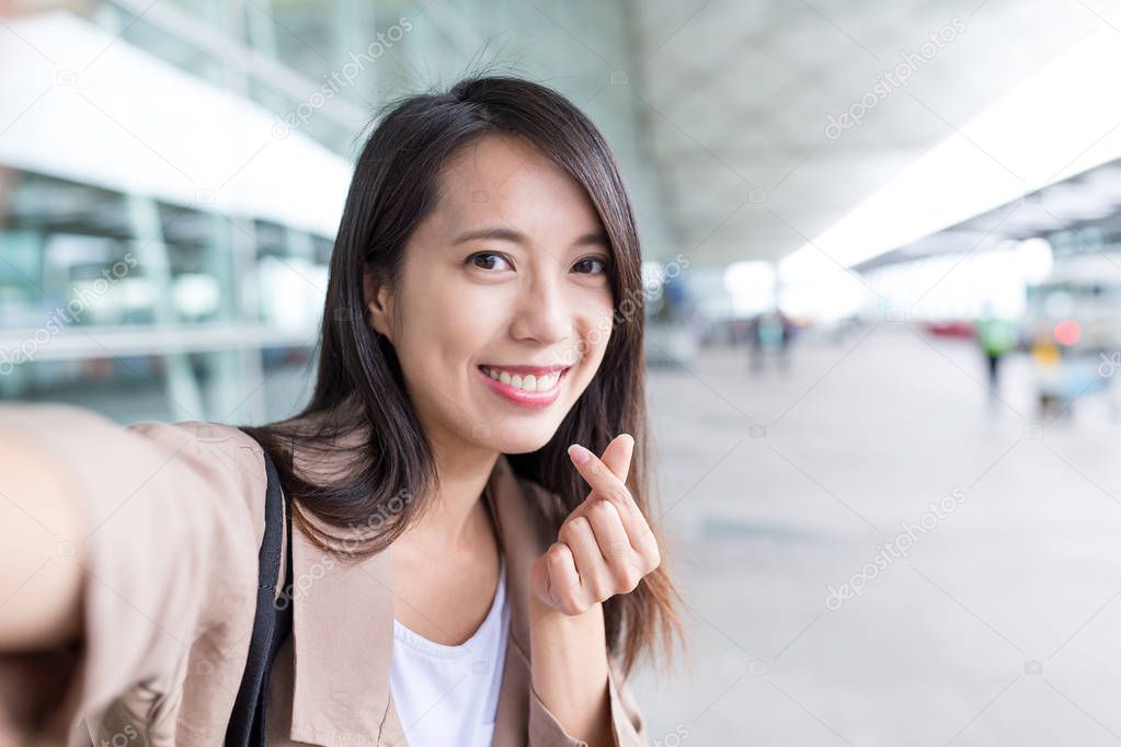 Woman taking selfie with korean style heart 