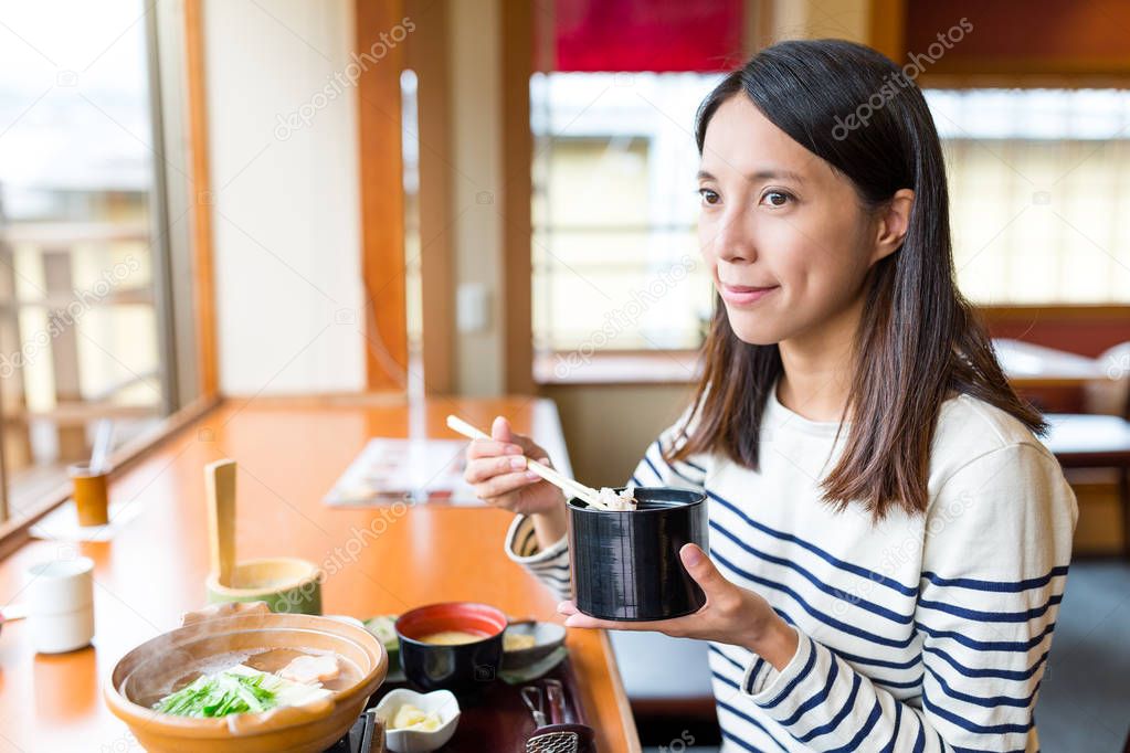 Woman having lunch in japanese restaurant