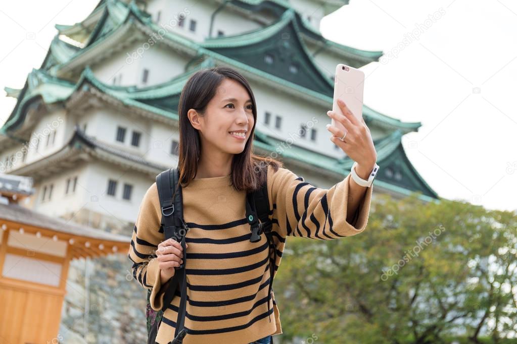 Woman taking photo with Nagoya castle 