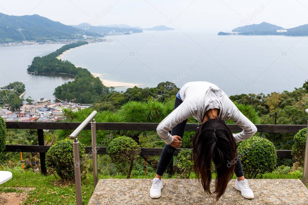 Woman upside down and viewing of Amanohashidate 