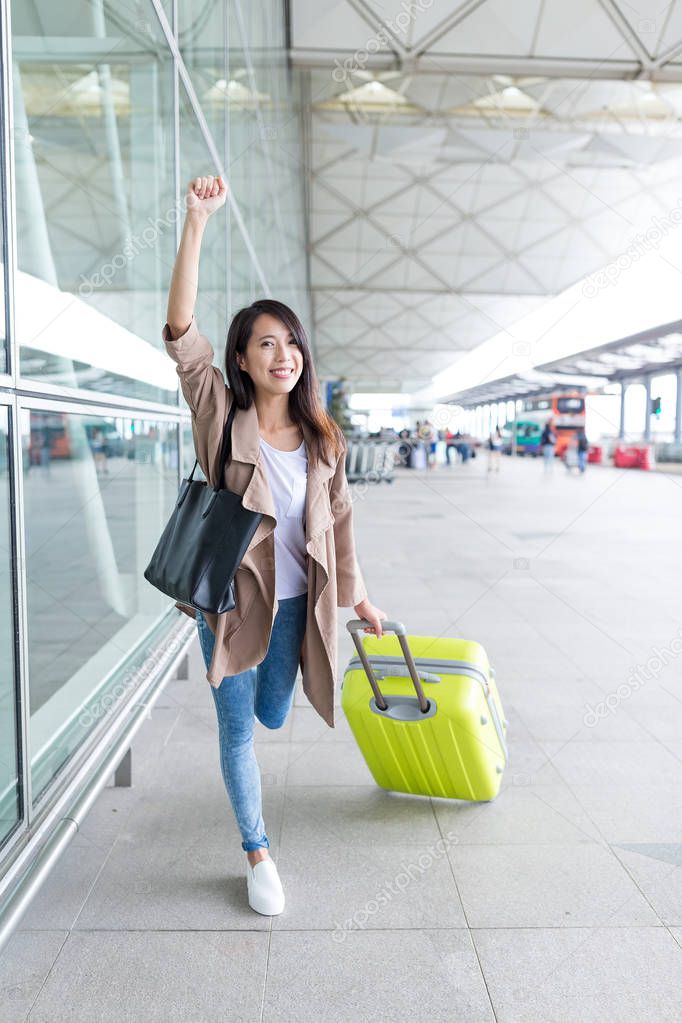Thrilled woman go travel in airport