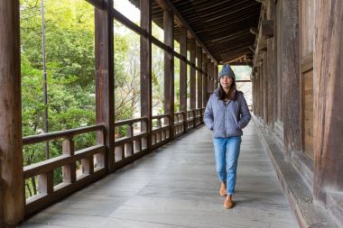 Woman walking in japanese wooden house clipart