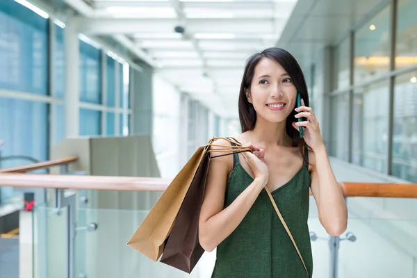 Woman go shopping and talking on cellphone