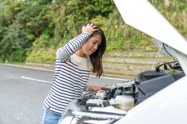 Woman having car problem at road