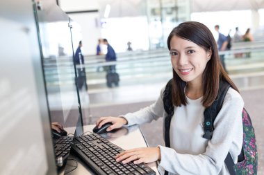 Havaalanında genel bilgisayar kullanan kadın