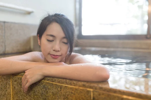 Женщина наслаждаться горячей ванной в помещении — стоковое фото