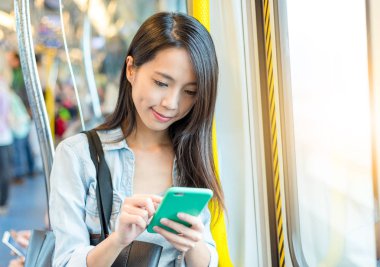 Tren cep telefonu üzerinde çalışan kadın