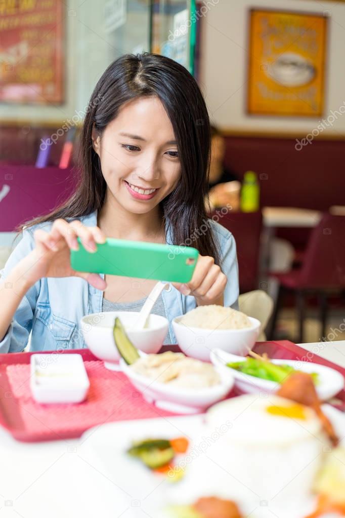 Woman taking photo on her dish 