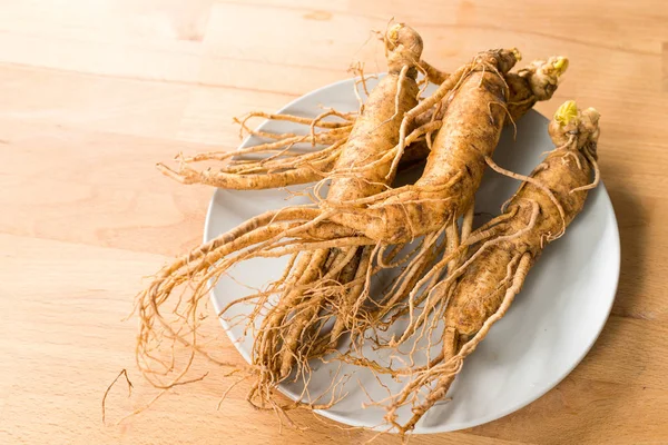 Fresh Ginseng on wooden table — Stock Photo, Image
