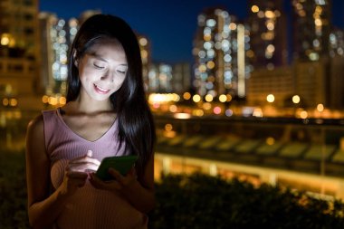 Şehirde cep telefonu kullanan bir kadın.