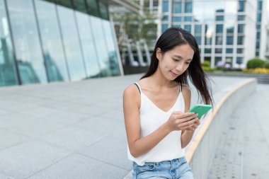 Şehirde cep telefonu kullanan bir kadın.