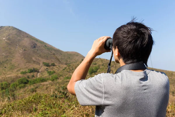 Man looking with binoculars