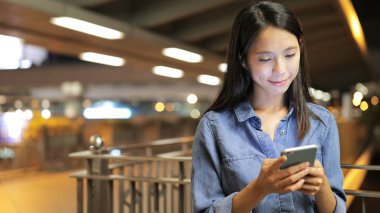 Gece akıllı telefon kullanan bir kadın. 