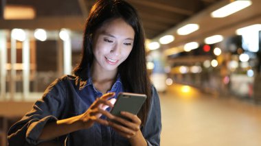 Şehirde akıllı telefon kullanan bir kadın. 