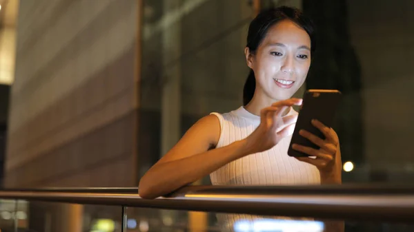 Woman sending text message on cellphone