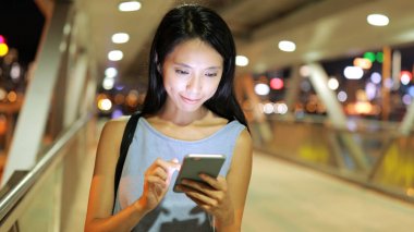 Yaya köprüsü cep telefonu kullanan kadın