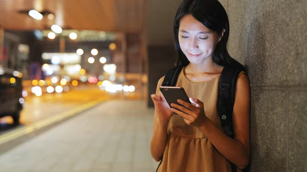 Vrouw die 's nachts een mobiele telefoon gebruikt — Stockfoto