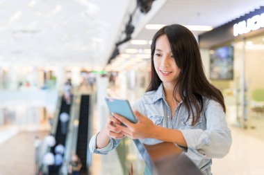 Alışveriş merkezinde Smartphone kullanan kadın