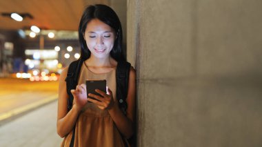 Gece akıllı telefon kullanan bir kadın. 