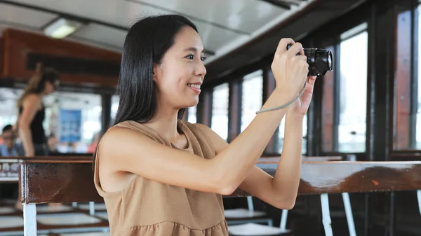 Traveler taking photo with digital camera on ferry — Stock Photo, Image