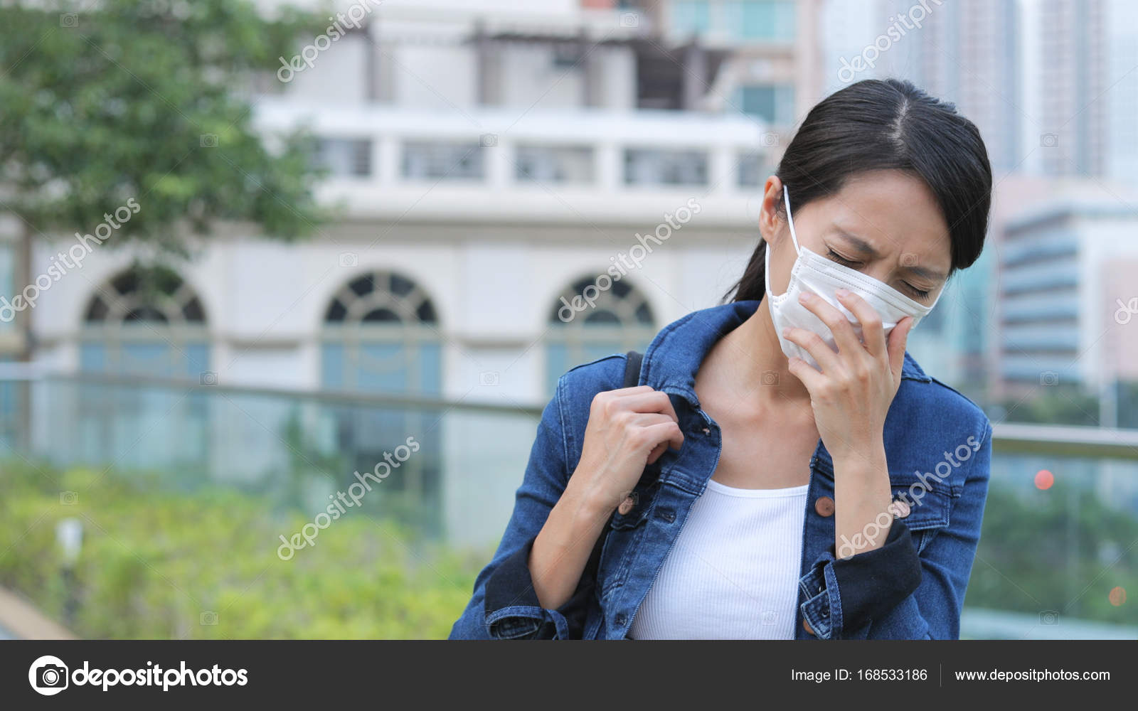 Woman sneeze and wearing face mask Stock Photo by ©leungchopan 168533186